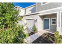 Townhome entrance with teal door and walkway, nicely landscaped at 3149 Novara Ln, Lakewood Ranch, FL 34211