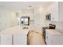 Bright kitchen featuring a large island and stainless steel appliances at 3149 Novara Ln, Lakewood Ranch, FL 34211