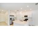 Modern kitchen with stainless steel appliances and white cabinetry at 3149 Novara Ln, Lakewood Ranch, FL 34211