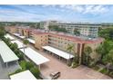 Aerial view of a condo building with parking and landscaping at 1300 N Portofino Dr # 208, Sarasota, FL 34242