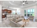 Bright, open living area with modern furnishings, tiled floors, and sliding glass doors to the outdoors at 11406 Belvedere Ter, Lakewood Ranch, FL 34211