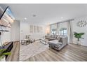 Bright and airy living room with gray sectional sofa and open floor plan at 1807 Robinhood St, Sarasota, FL 34231