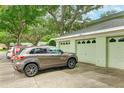 Parking area with multiple garages and cars parked in front at 7280 Eleanor Cir # 201, Sarasota, FL 34243