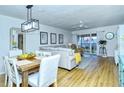 Bright living room with a dining area, featuring light wood floors and a neutral color scheme at 1801 Gulf N Dr # 275, Bradenton Beach, FL 34217