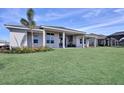 Expansive backyard with green grass and a covered patio at 8062 Nevis Run, Bradenton, FL 34202