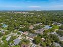 Aerial view showing a beautiful neighborhood with lush greenery and a coastal backdrop at 2633 Marlette St, Sarasota, FL 34231