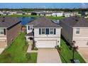 Two-story house with a two-car garage and solar panels on the roof at 2966 Great Abaco Way, Bradenton, FL 34208