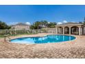 Community pool with patio and lounge chairs at 14813 Skip Jack Loop, Lakewood Ranch, FL 34202