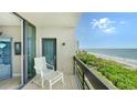 Balcony with chair and ocean view,sliding doors lead inside at 1045 Gulf Of Mexico Dr # 403, Longboat Key, FL 34228