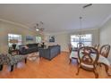 Bright living room featuring hardwood floors, comfortable seating, a ceiling fan, and plenty of natural light at 11622 Summit Rock Ct, Parrish, FL 34219