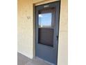 Exterior condo entry with a dark gray screen door at 3780 Lake Bayshore Dr # K-521, Bradenton, FL 34205