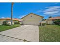 Front view of a single-story house with garage at 4223 Murfield E Dr, Bradenton, FL 34203