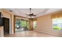 Spacious bedroom features tiled floors, ceiling fan, natural light, and sliding doors leading to a screened patio at 4830 Maymont Park Cir, Bradenton, FL 34203