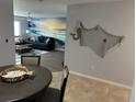 Open concept dining area with ocean-themed wall art at 3979 Cape Haze Dr # A1, Rotonda West, FL 33947