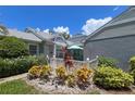 Landscaped front yard featuring a white picket fence, garden, and cozy outdoor seating area at 3423 52Nd Avenue W Cir # 267, Bradenton, FL 34210