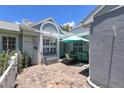 Charming home with a brick patio and outdoor seating under a blue umbrella, perfect for relaxing at 3423 52Nd Avenue W Cir # 267, Bradenton, FL 34210