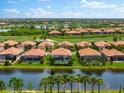 Aerial view of luxury homes with pools, situated along a canal and golf course at 25081 Spartina Dr, Venice, FL 34293