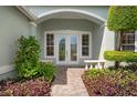Inviting front entrance with double doors and landscaped walkway at 5249 Far Oak Cir, Sarasota, FL 34238