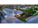 Charming two-story home with a well-maintained lawn, pink shutters, an attached garage, and driveway at 508 65Th St, Holmes Beach, FL 34217