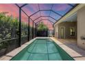Screened-in rectangular pool with spa and sunset view at 14215 Kinglet Ter, Lakewood Ranch, FL 34202