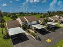 Aerial view of condo with carport parking and lush landscaping at 684 Bird Bay W Dr # 132, Venice, FL 34285