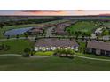 Aerial view of townhome on golf course at sunset at 5664 Palmer Cir # 202, Bradenton, FL 34211