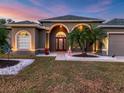 Attractive house exterior with a welcoming entryway and landscaping at 17706 Bridlewood Ct, Parrish, FL 34219