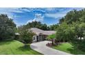 Aerial view of a single Gathering home with a large driveway and lush green lawn at 815 128Th Ne St, Bradenton, FL 34212