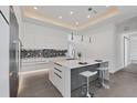 Modern kitchen with white cabinets, island, and stainless steel appliances at 2234 Hibiscus St, Sarasota, FL 34239