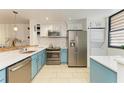 Modern kitchen with teal cabinets, stainless steel appliances, and quartz countertops at 184 Pineneedle Dr # 184, Bradenton, FL 34210