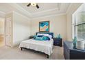 Comfortable bedroom boasts tray ceiling and ample natural light, creating a relaxing retreat at 13215 Ramblewood Trl, Bradenton, FL 34211