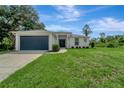 Single story home with a dark blue garage door at 1174 S Mcduff St, North Port, FL 34288