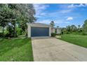 Single story home with a dark blue garage door at 1174 S Mcduff St, North Port, FL 34288