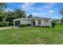 Single story home with a dark blue garage door at 1174 S Mcduff St, North Port, FL 34288