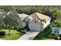 Single-story home with tile roof and lush landscaping at 7275 Lismore Ct, Lakewood Ranch, FL 34202