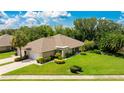 Single-story house with a large green lawn and driveway at 4098 Fairway Pl, North Port, FL 34287