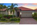 Single-Gathering home with two-car garage and landscaped front yard at 177 Vinadio Blvd, Nokomis, FL 34275