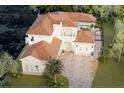 An aerial view of a two-story house with a tile roof and pool at 3523 Trebor Ln, Sarasota, FL 34235