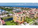 This aerial view showcases the home's prime location near the water, complemented by a rooftop terrace and a two car garage at 1450 Silvia Shores Dr, Apollo Beach, FL 33572