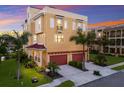 Beautiful home featuring a spacious driveway, multi-car garage, and tropical landscaping with palm trees at 1450 Silvia Shores Dr, Apollo Beach, FL 33572