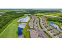 Picturesque aerial view of the condominium complex next to a golf course and serene lakes at 17704 Gawthrop Dr # 402, Bradenton, FL 34211