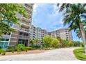 Luxury condo building with lush landscaping and palm trees at 808 3Rd W Ave # 514, Bradenton, FL 34205