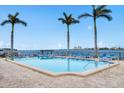 Inviting community pool with waterfront views and lounge chairs at 5200 Brittany S Dr # 602, St Petersburg, FL 33715