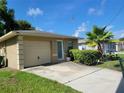 Tan house with a one car garage and chain link fence at 707 13Th W St, Palmetto, FL 34221