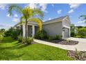 Gray house with palm trees and a walkway at 10417 Crooked Creek Ct, Parrish, FL 34219