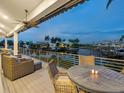 Relaxing waterfront deck with wicker furniture and stunning canal views at 5727 Riegels Point Rd, Sarasota, FL 34242
