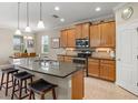 Modern kitchen with wood cabinets, granite countertops, and stainless steel appliances at 8214 Las Lilias Ct, Sarasota, FL 34243