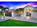 Single-story home with a landscaped yard at sunset at 158 Allworthy St, Port Charlotte, FL 33954