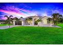 Single-story home with a landscaped yard at sunset at 158 Allworthy St, Port Charlotte, FL 33954
