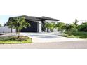 Spacious driveway leading to a modern home with a two-car garage at 11061 Sandrift Ave, Englewood, FL 34224